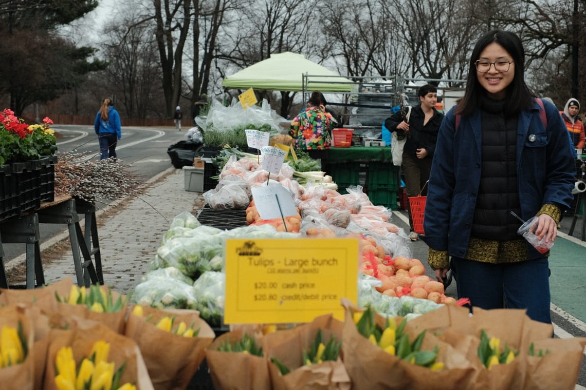 A woman smiling while shopping in the local mart