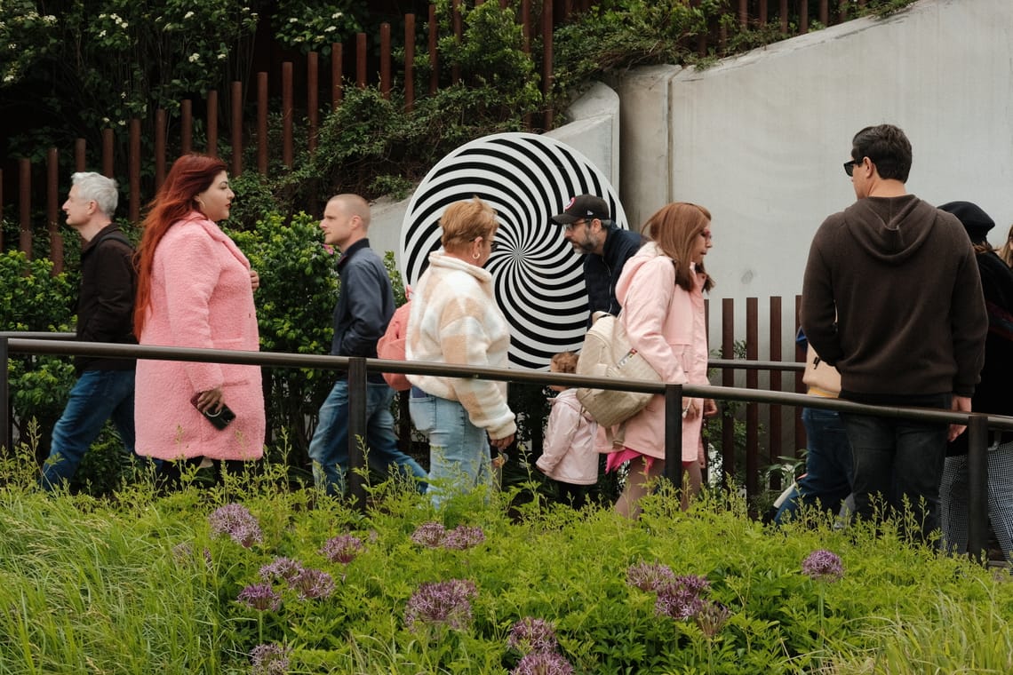 People walking in a public park near the Hudson river